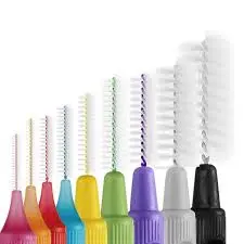 Color-coded interdental brushes of varying sizes arranged in a row from smallest to largest, used for cleaning between teeth and maintaining oral hygiene